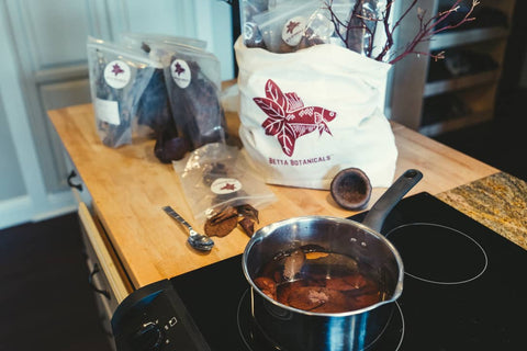 Aquarium botanicals like catappa leaves being prepared on a stovetop by Betta Botanicals.