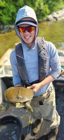 Calvin Darling is seen here holding a turtle in his hands.