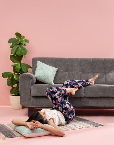 Image of a woman lying down wearing Go Colors Lounge Pants.