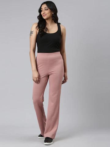 Image of a woman wearing Go Colors ponte bell-bottoms.