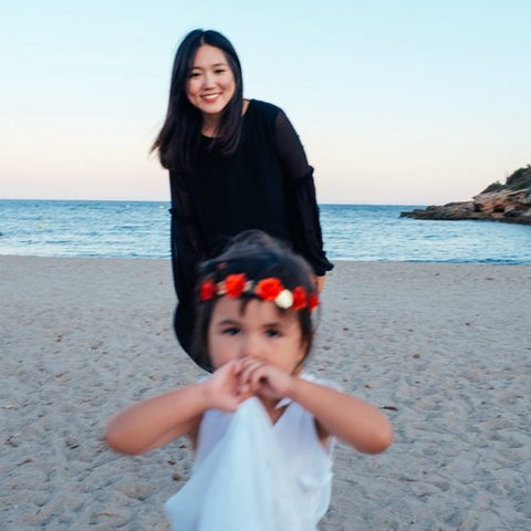 Image of Inyoung Kim with her child on the beach.