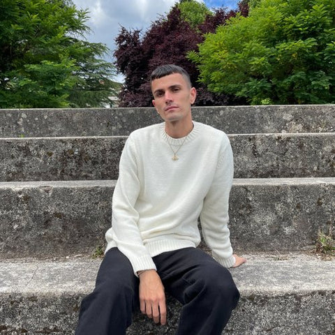 Image of Pablo Aneiros sitting on a stone stairway.