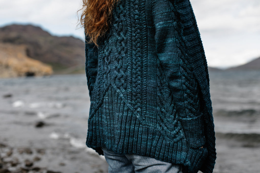 Image of the Sode cardigan in petrol blue, from the back.