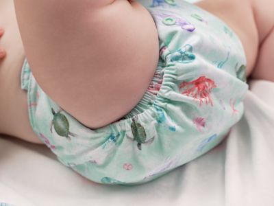 Close up image of baby wearing a double gusset cloth nappy / double leg elastic