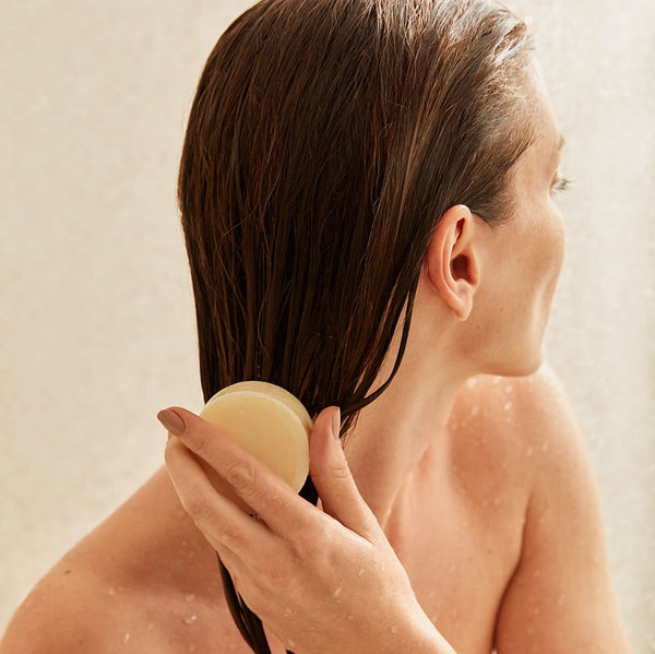 Girl applying Conditioner Bar on her hair