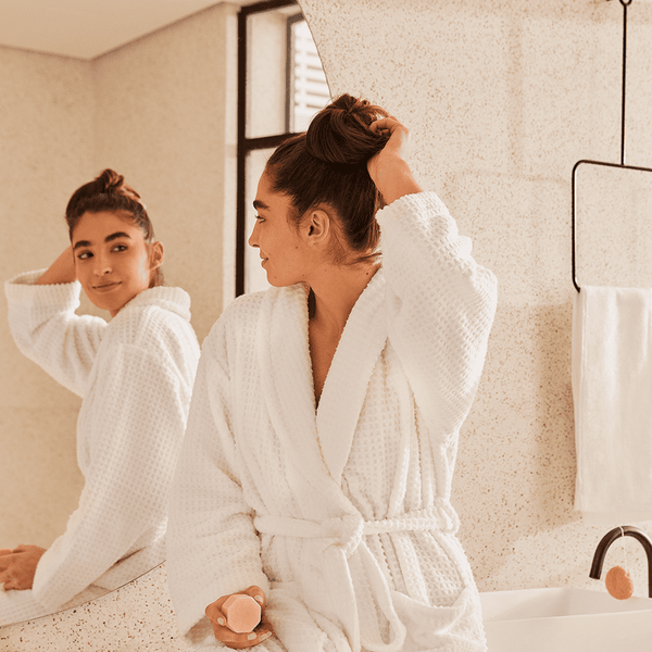 girl checking her hair on the mirror