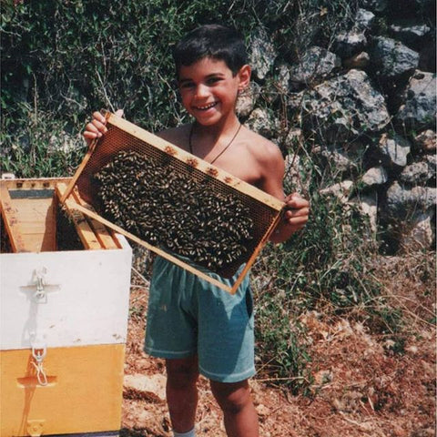 Photo of Greek honey farming family and boy holding honey