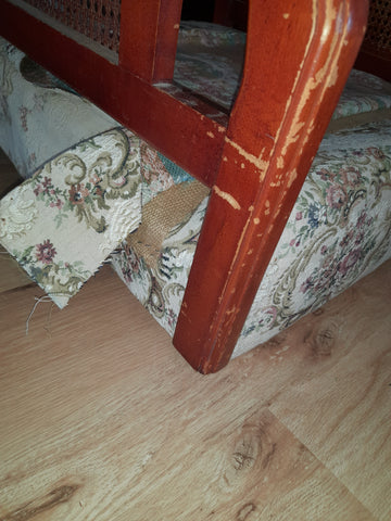 Removal of the existing upholstery on the single timber & rattan armchair