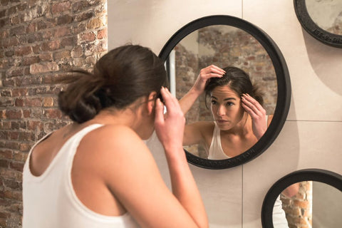 Woman checking on hair loss