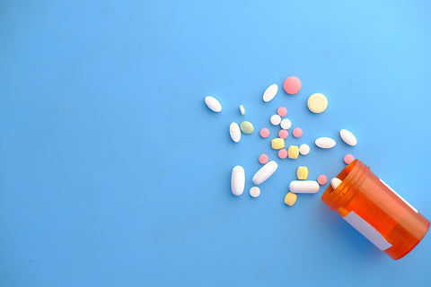 Yellow Athletic photo of pills spilling out of bottle