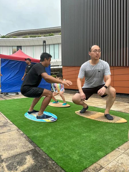 People Practicing on Skimboards