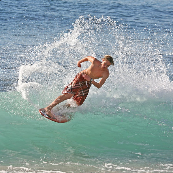 Guy on Skimboard in the ocean