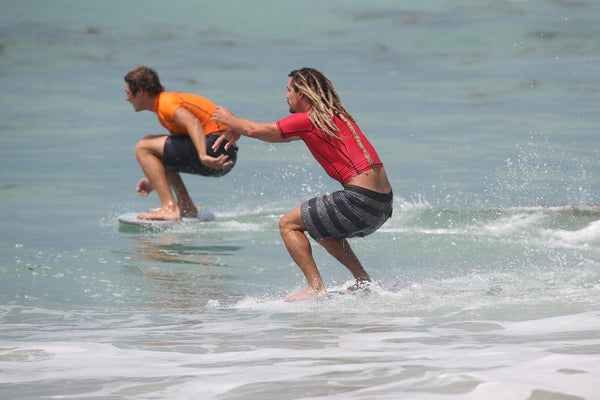 Two men on Skimboards