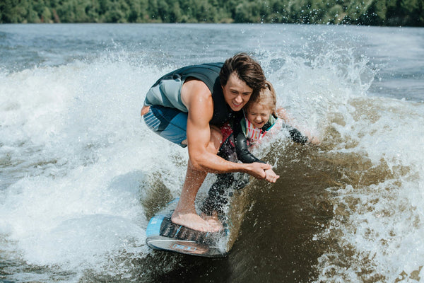 Man and Child Wakesurfing