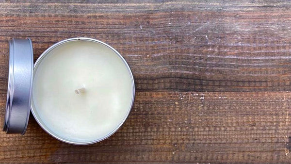 view down onto candle tin on wooden board