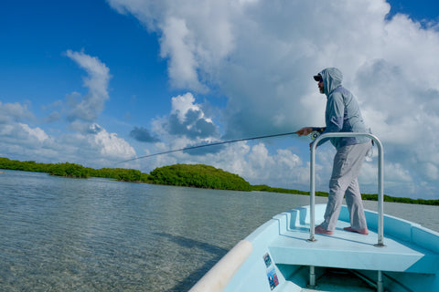 Ryan casts at cruising bonefish on the flats of Belize in the Skwala Tactical Hoody and Wading Pants. 