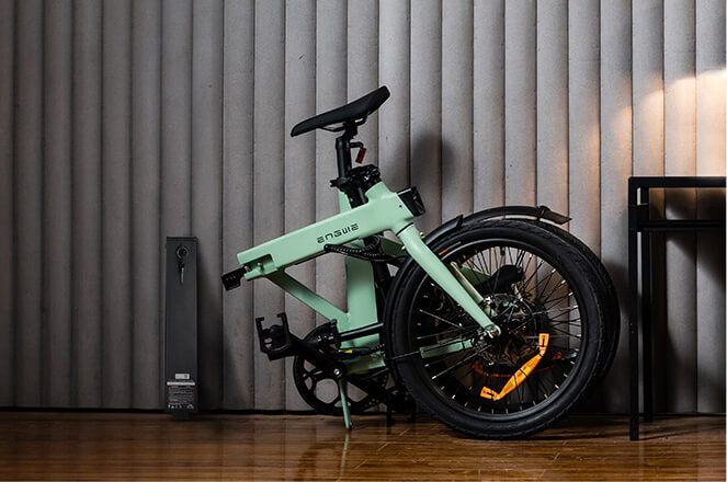 a folded engwe p20 lightweight electric bike and its battery in the room