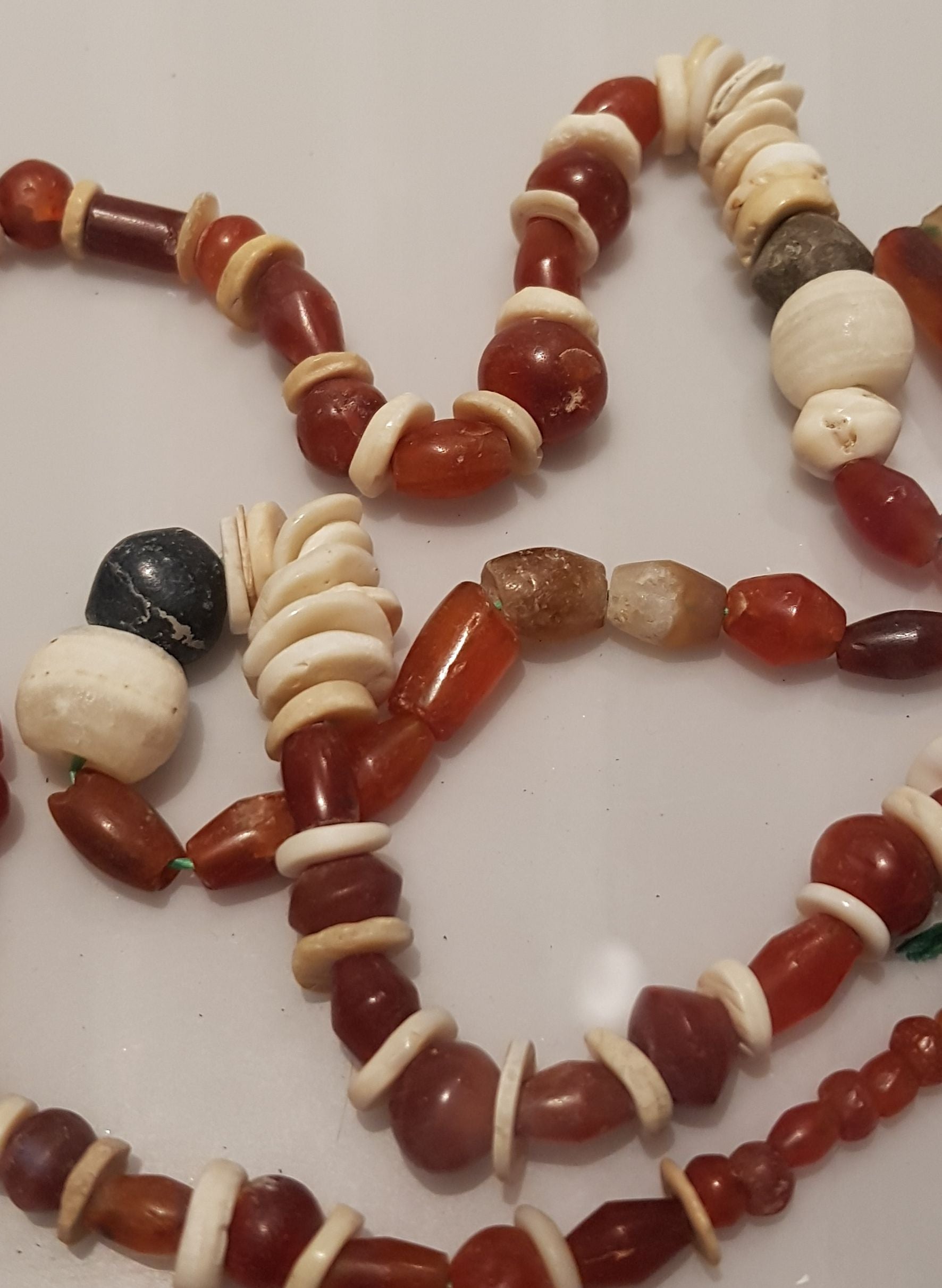 A necklace of carnelian and other materials, including bone, found at Saruq Al Hadid.
