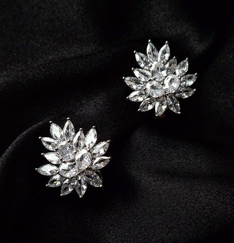 a pair of Cluster Earrings made of cubic zirconia showcased on a black fabric