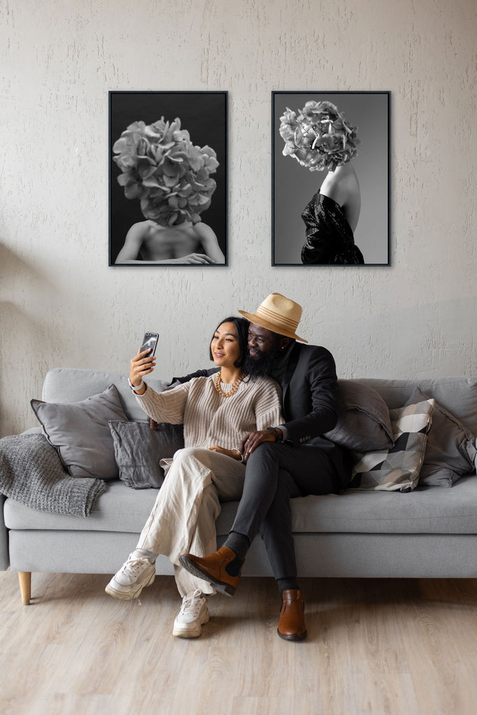 Couple on the sofa with two artwork above them on the wall