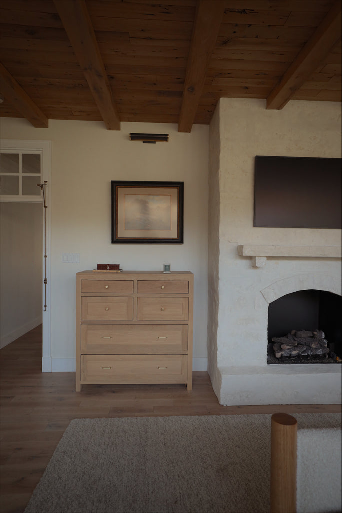 cabin inspired primary bedroom with stone fireplace