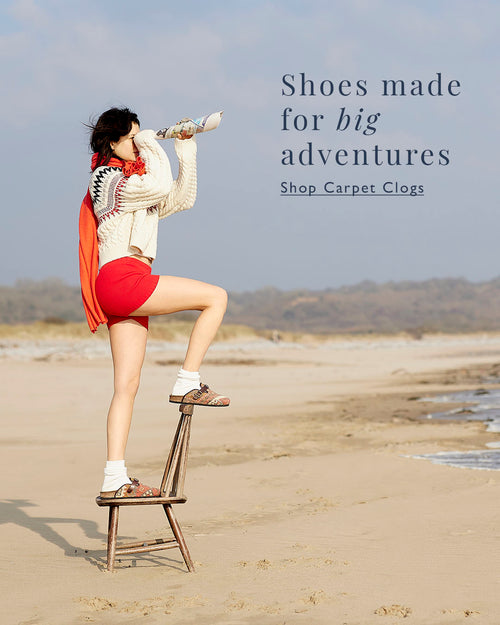 Model wearing carpet clogs looking out to sea 