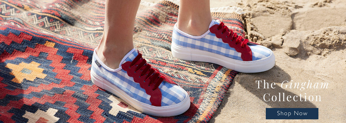 Gingham sneakers on a kilim rug on the beach 