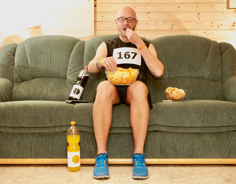 man athlete on sofa eating fuelling for sport