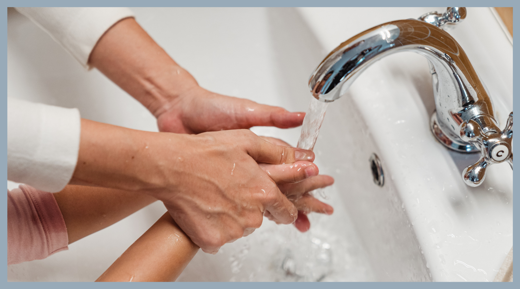 mum showing child how to wash her hands