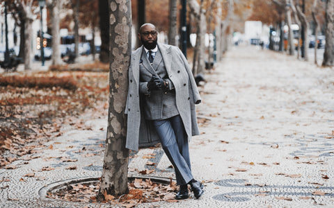 Man Wearing Suit and Tie Leaning Against Tree