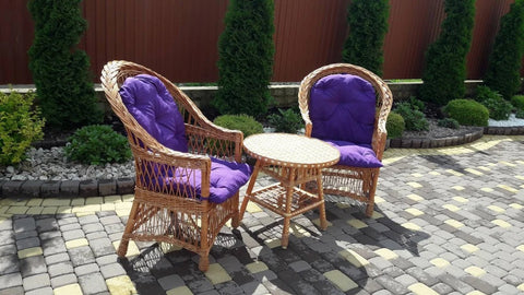 Wicker furniture set with purple cushions