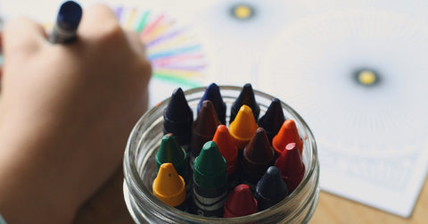 Closeup of child's hand as they color a picture with crayons