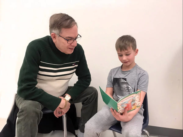 Col. Abel reading with a student