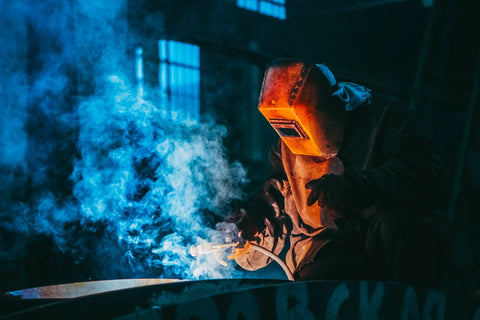 Person Welding Wearing a Protective Metal Mask