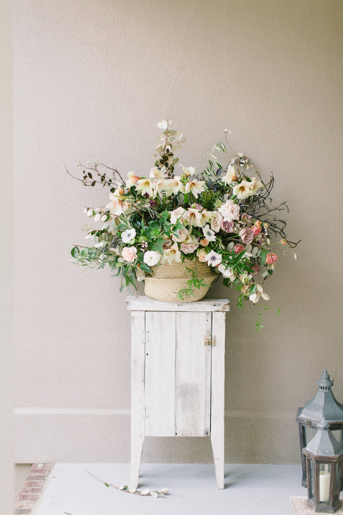 luxury pastel flowers in basket on a white table