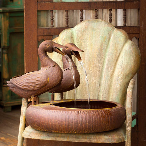A charming addition to any patio or garden, this folk art inspired duck fountain features an aged, rusted metal finish. The ducks bills open and close with the flow of water. Submersible pump and splash screen included.  Color & Finish: Rusted metal finish Finish may vary Find this item and more in our Garden Floral Collection Imported