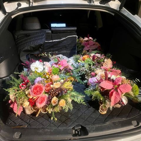 Tesla loaded with colorful pink blue yellow luxury flower centerpieces atlanta