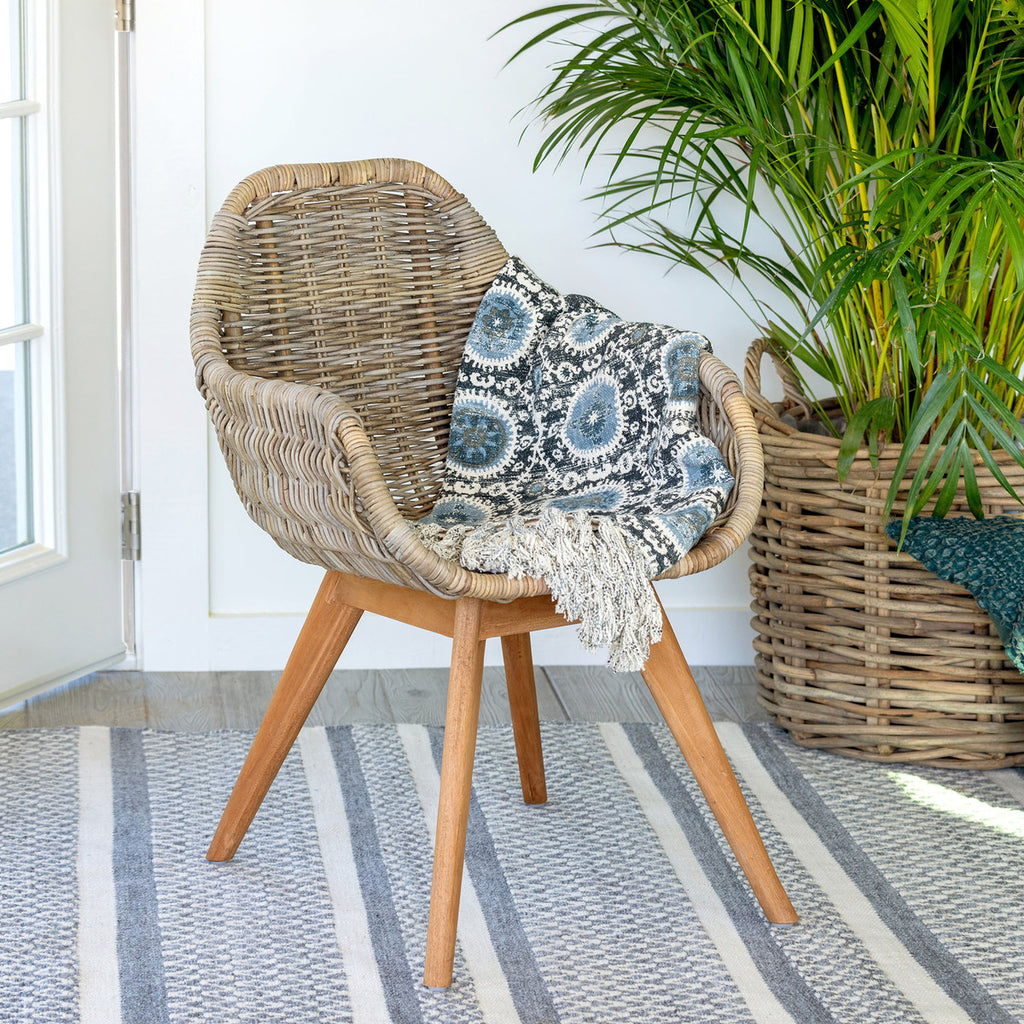 Rattan Lounge Chair with blue cushion and blanket
