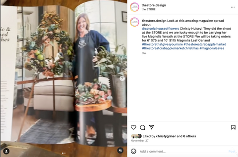 happy florist in blue jumper with wreath on instagram