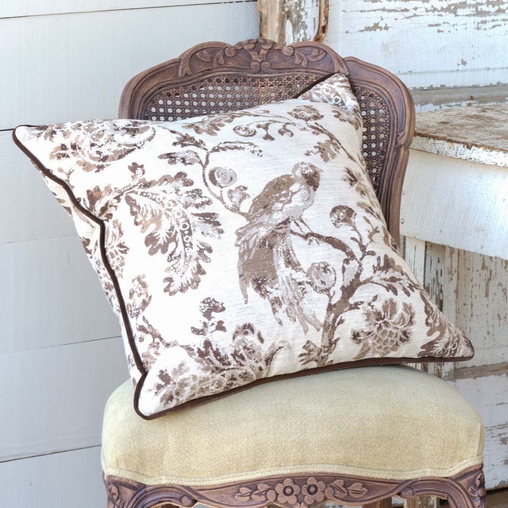 Brown and White Down Pillow on velvet chair