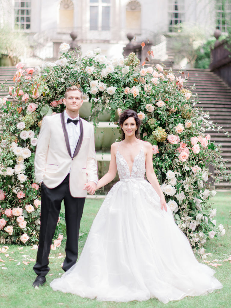 Blush Pink Organic Floral Arch With Man and Woman in front of Swan House in Atlanta, Georgia 