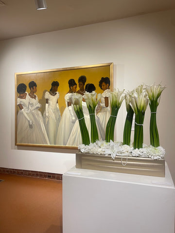 Antebellum artwork with brown women and white calla lily at art museum