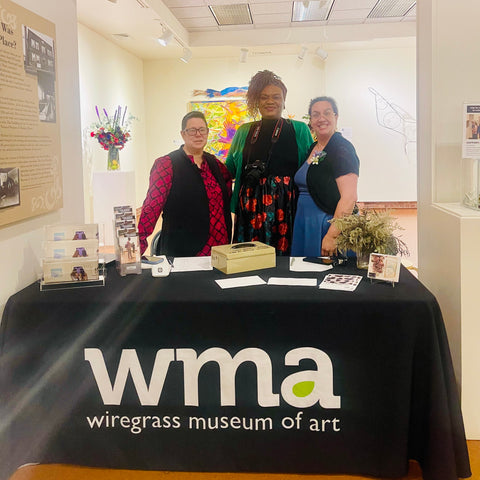 Three women at Art in Bloom flower table in Dothan Alabama