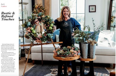 luxury wreath on wood easel with happy smiling female florist in blue jumper in milton georgia