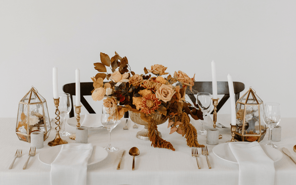 Bouquet of dried flowers and leaves as centerpiece of a set table