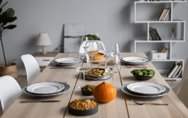 Table setting with table, glasses, snack and a pumpkin