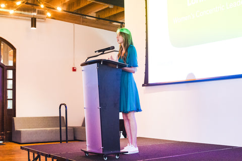 loryna speaking on stage at the fall luncheon