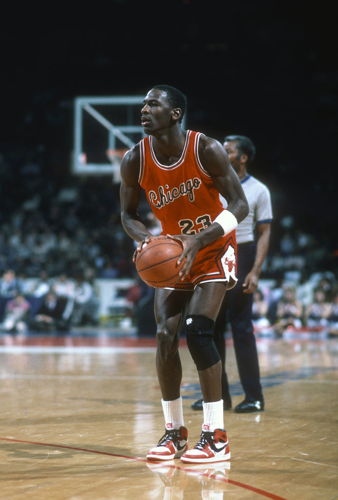 Vintage image of Michael Jordan wearing Air Jordan 1 Mids on court