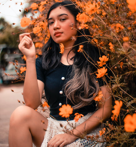 latina woman and orange flowers