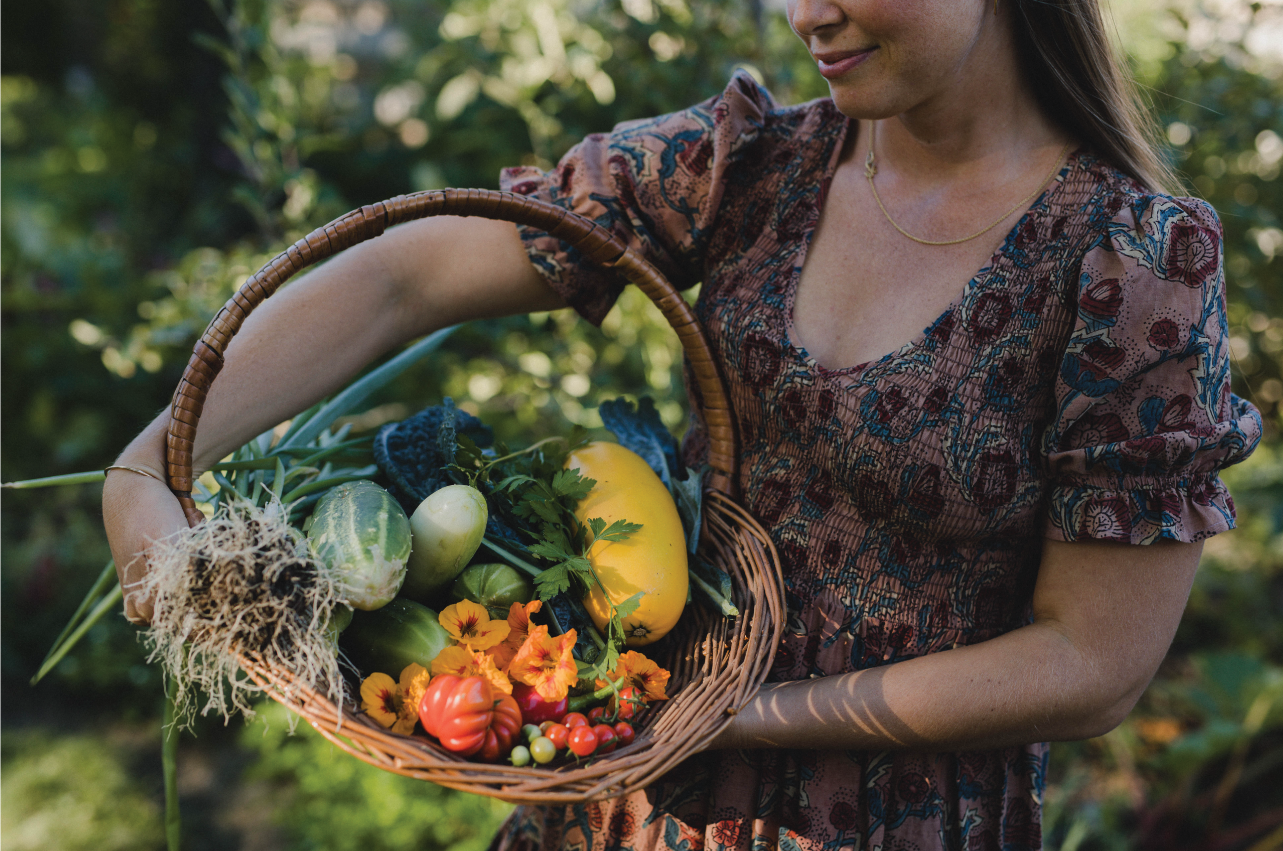 Sarah Britton holding a basket of fresh vegetables